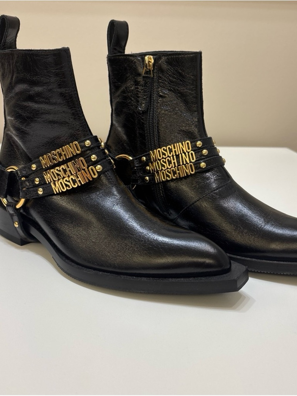 Never worn Moschino Black Leather Ankle Boots with Gold Logo Straps